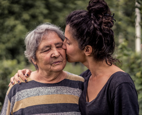 Family Caregiving: Daughter Kissing Mother