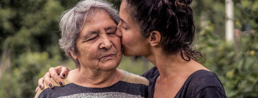 Family Caregiving: Daughter Kissing Mother